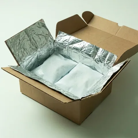 Insulated shipping carton lined with foil and cold packs